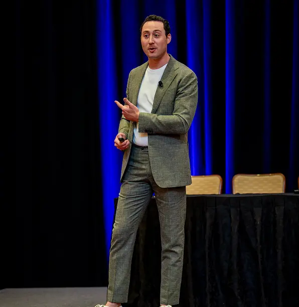 person on the stage speaking in front of audience