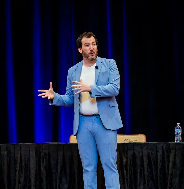person on the stage speaking in front of audience